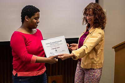 Professor Tamara Stenn presents the Diane Wood Award to student Sophia Spraggins.